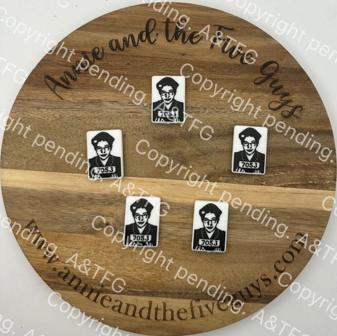 Rosa Parks Silicone focal bead with four rectangular pieces, each bearing a black and white portrait with text "7053". The board is branded with "Annie and the Five Guys" and has copyright marks.