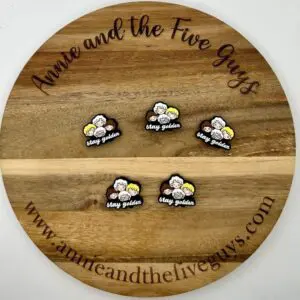 A wooden board with the text "3D tooth (Copy)" displays five embroidered patches featuring cartoon characters and the phrase "stay golden." The website "www.annieandthefiveguys.com" is at the bottom.