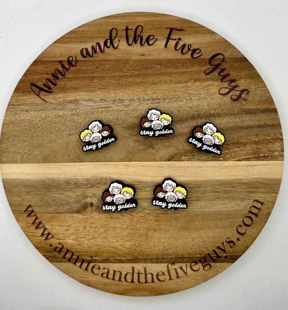 A wooden board with the text "3D tooth (Copy)" displays five embroidered patches featuring cartoon characters and the phrase "stay golden." The website "www.annieandthefiveguys.com" is at the bottom.