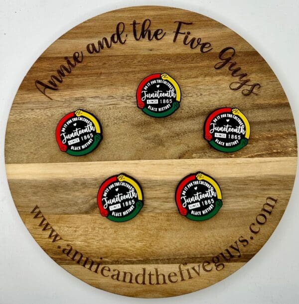 A round wooden plaque with the text "Annie and the Five Guys" displays five Juneteenth celebration badges arranged in a circle.