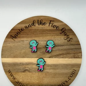 Three **Honey bear or tiger silicone focal beads (Copy)** are placed on a wooden board engraved with the text "Annie and the Five Guys" and featuring a website URL at the bottom.