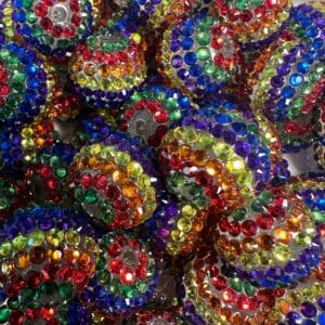 A collection of round beads covered in multicolored rhinestones, including red, blue, green, yellow, and purple.