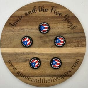 A wooden board with the text "Annie and the Five Guys" holds four round buttons labeled "Puerto Rico," each featuring the Puerto Rican flag. The website "www.annieandthefiveguys.com" is at the bottom.