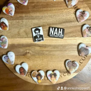 A wooden board displays 16 heart-shaped and two rectangular pins. The rectangular pins feature an image of Rosa Parks and the text "NAH." This setup is credited to anniesheppard1 on TikTok.