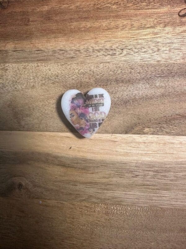 African American, African queens silicone focal beads on a wooden surface featuring a woman's profile and the text, "Even in the midst of my storm, I see God working it out for me.