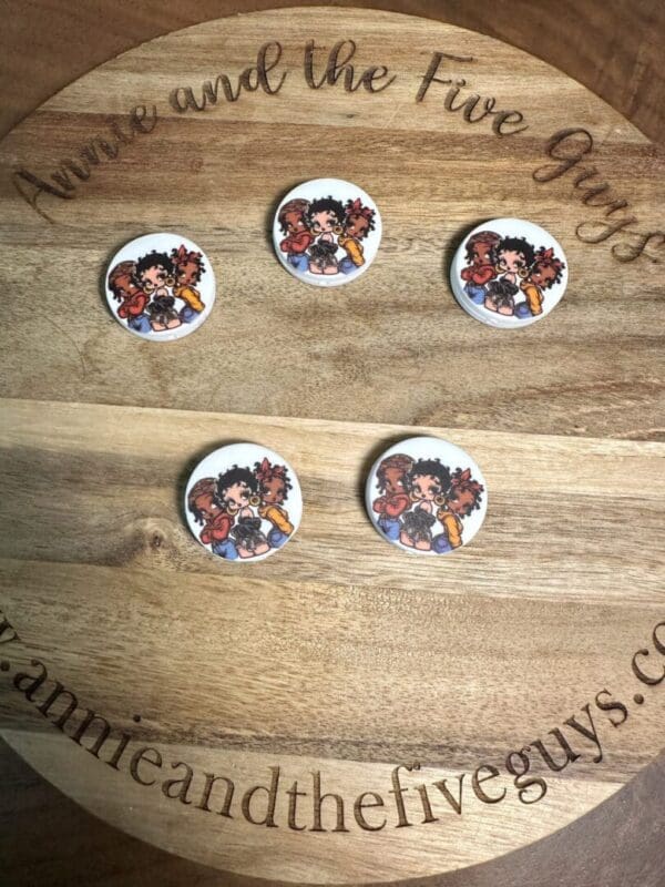 Five Betty Boop silicone focal beads, multicultural, are arranged on a wooden surface with the text "annieandthefiveguys.com" partially visible.