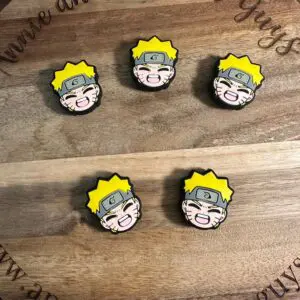 Four pins featuring an animated character's face with yellow hair and a headband on a wooden surface with text "Annie and the Five Guys".