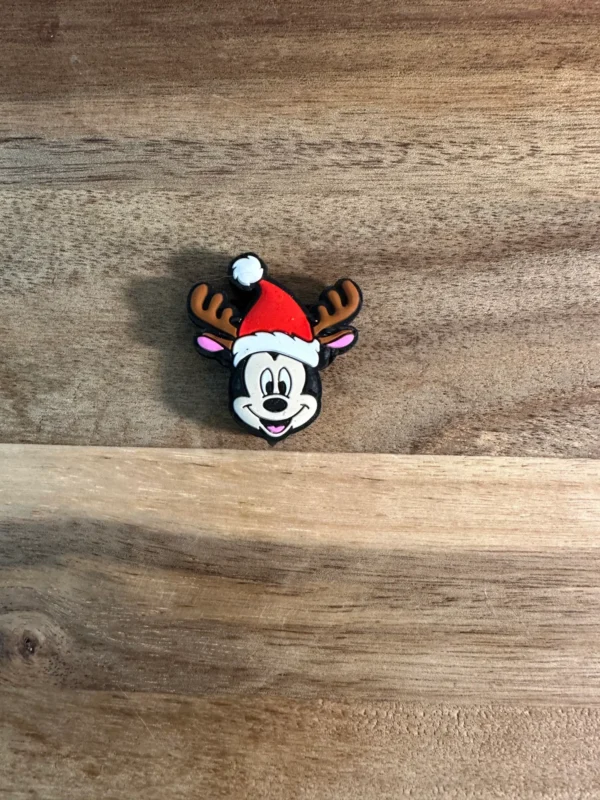 A small Christmas or Easter mouse silicone focal bead featuring a smiling mouse character wearing a Santa hat with reindeer antlers on a wooden surface.