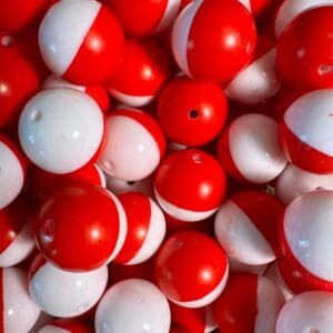 A pile of 20MM red and white Chunky Bubblegum Beads, 20MM candy bead, 20mm Bubble Gum Beads, 20mm Beads, 4 beads per pack with small holes on their surfaces.