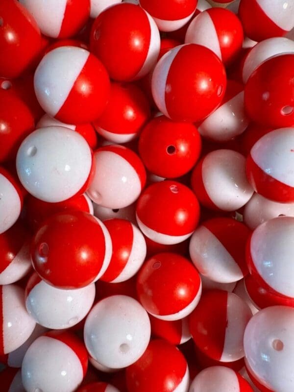 A pile of 20MM red and white Chunky Bubblegum Beads, 20MM candy bead, 20mm Bubble Gum Beads, 20mm Beads, 4 beads per pack with small holes on their surfaces.