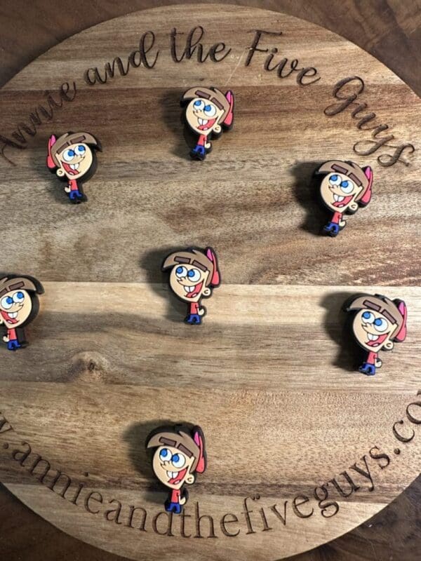 A wooden board with six pins featuring Timothy Turner from Fairly Odd Parents, sporting a pink hat and a smile. The board reads "Annie and the Five Guys" and shows the website www.annieandthefiveguys.com.