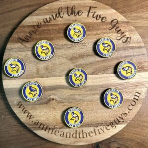 Nine Minnesota football silicone focal brads, each adorned with a Viking logo and the text "Waltheson Vikings," are arranged on a round wooden board engraved with "Annie and the Five Guys" and the website "www.annieandthefiveguys.com".