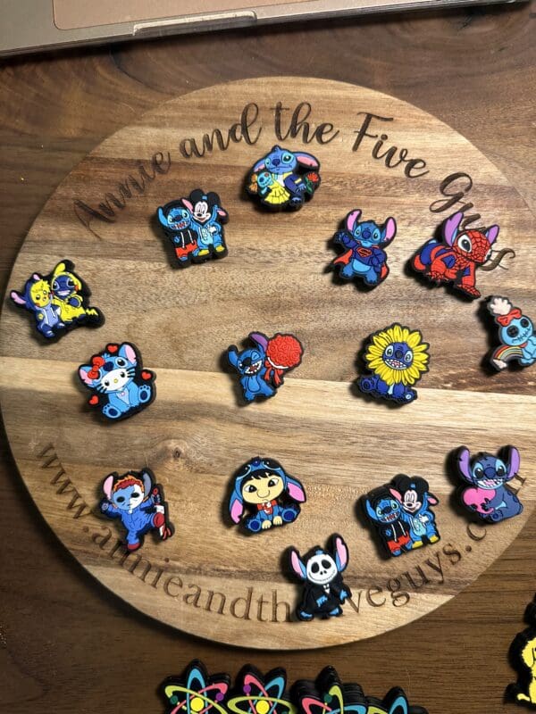 Wooden circular board displaying colorful pins of cartoon characters dressed in various costumes.