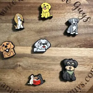 Wooden board with cartoon dog pins displayed, featuring various breeds and a website URL around the edge.