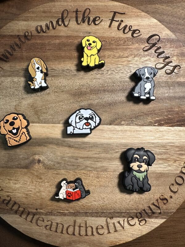 Wooden board with cartoon dog pins displayed, featuring various breeds and a website URL around the edge.