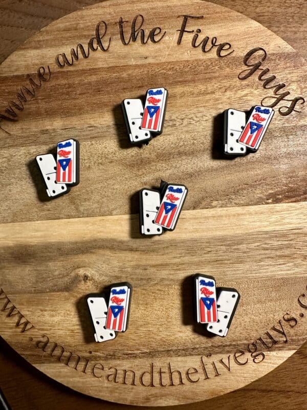 Wooden board displaying six Domino pieces with Puerto Rican flag design and "Annie and the Five Guys" branding.