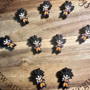 Nine mini figurines of an animated character on a wooden surface.